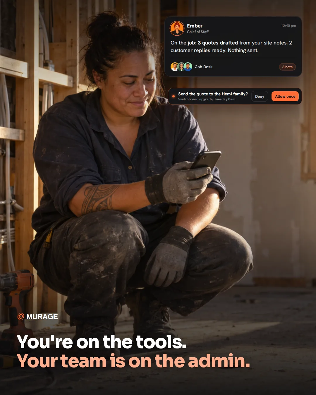You're on the tools. Your team is on the admin. An electrician crouched by an open wall on a renovation job, reading her phone, while Ember reports quotes drafted from her site notes and one waits for her Allow once.