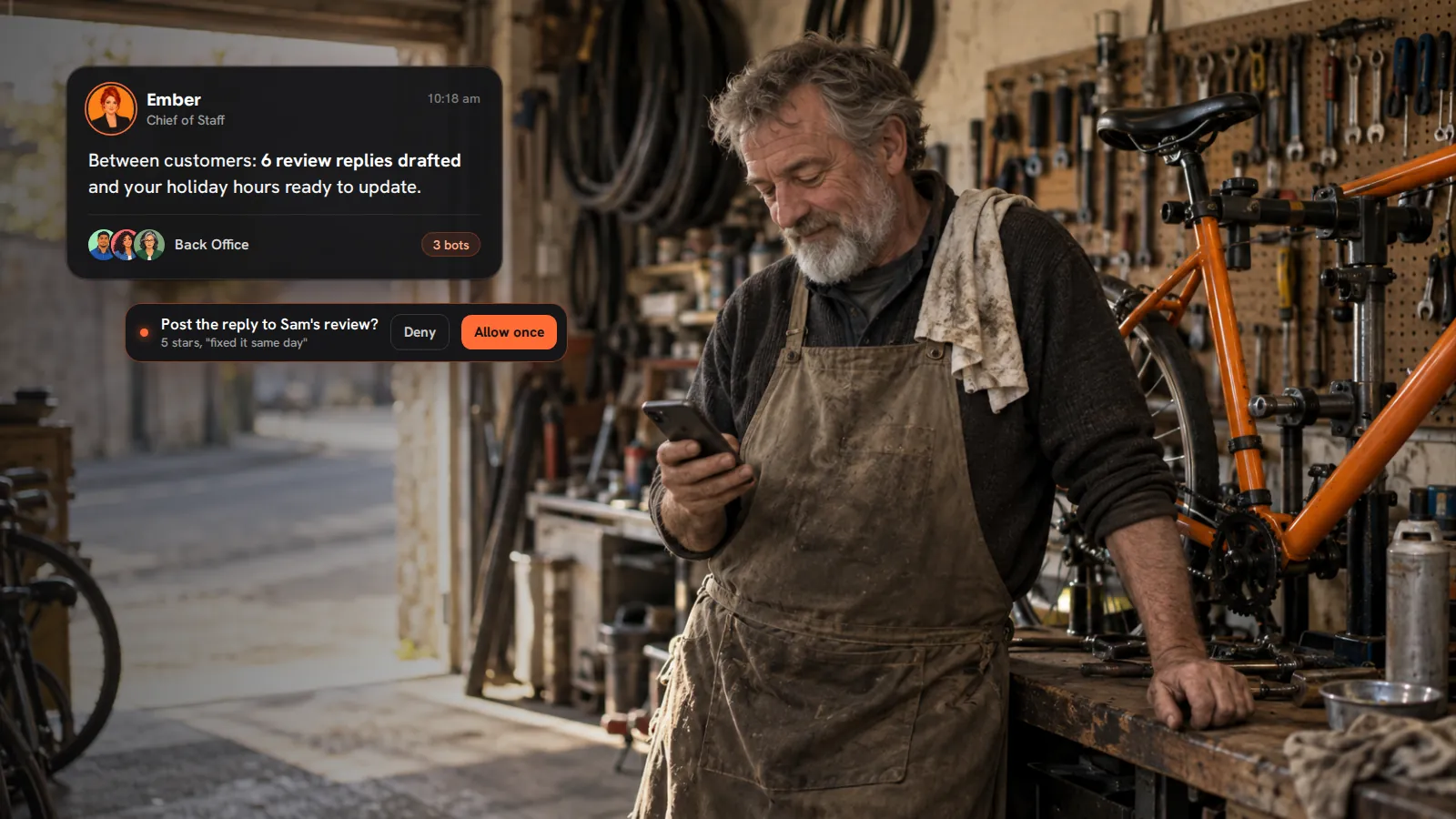 A bike shop owner glancing at his phone between customers, while Ember reports review replies drafted and asks before posting one.