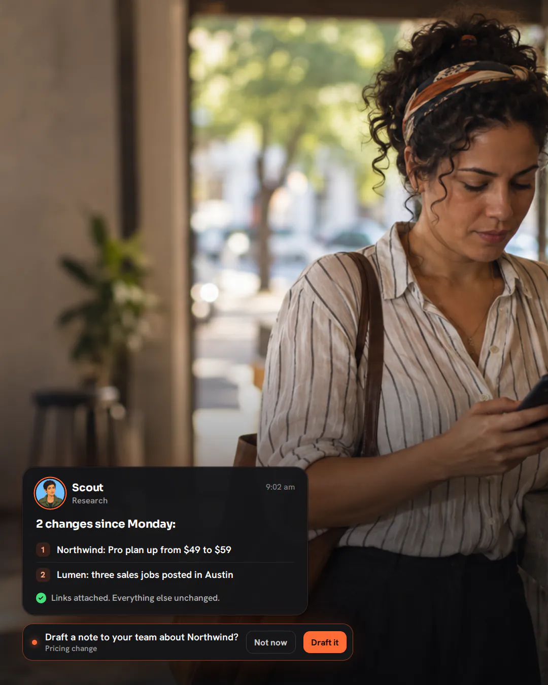 A software founder at a café counter in the morning, drinking an espresso and glancing at her phone.