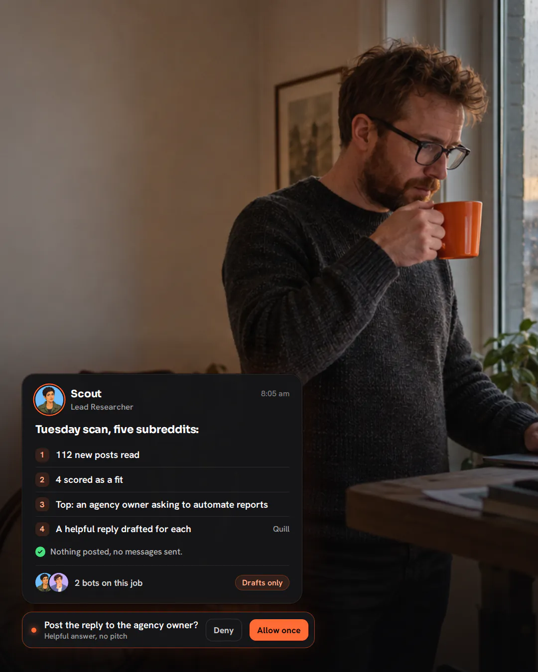 A software founder at a standing desk by a rainy window, holding a mug of tea and reading his laptop.